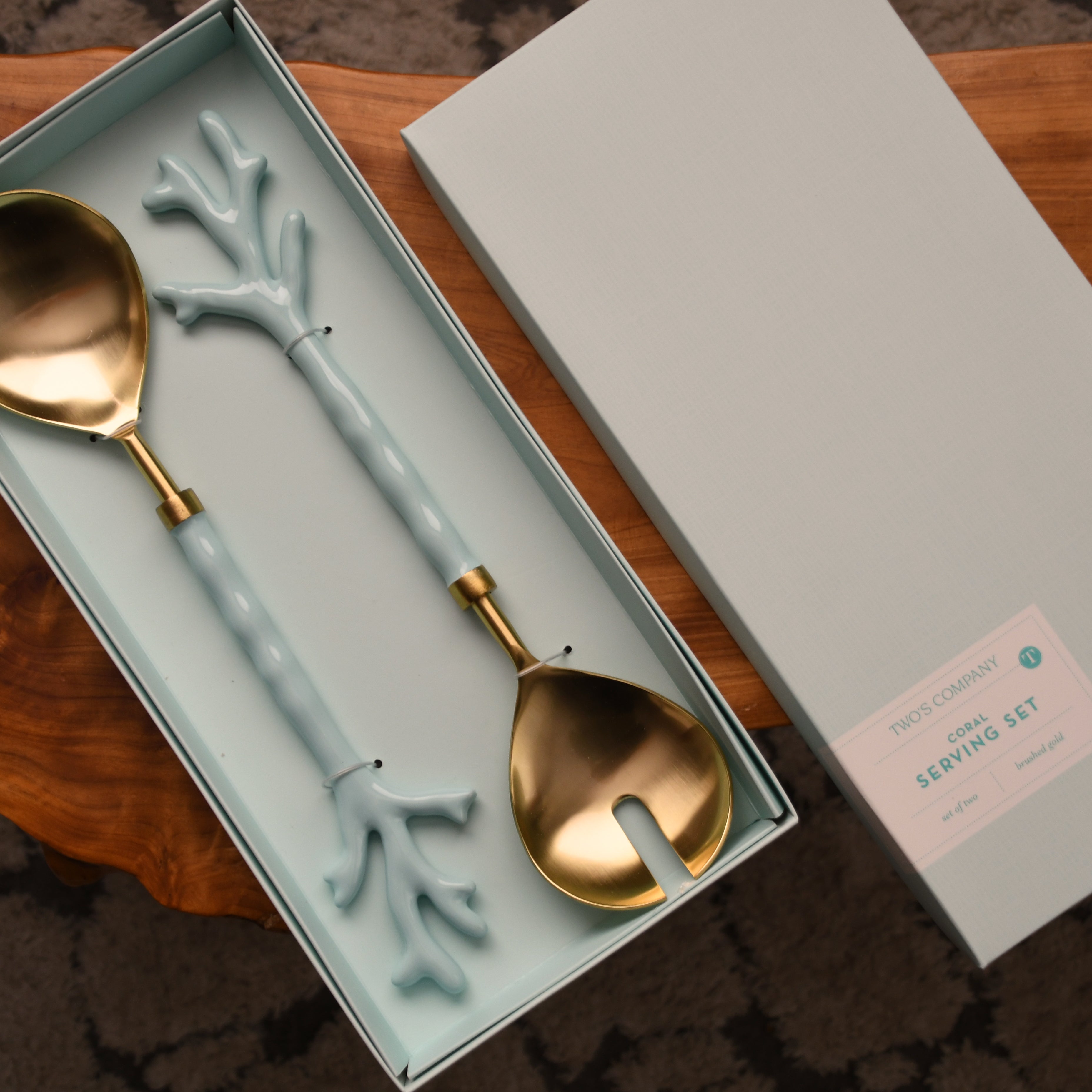 Set of decorative spoons in a box on a wooden surface