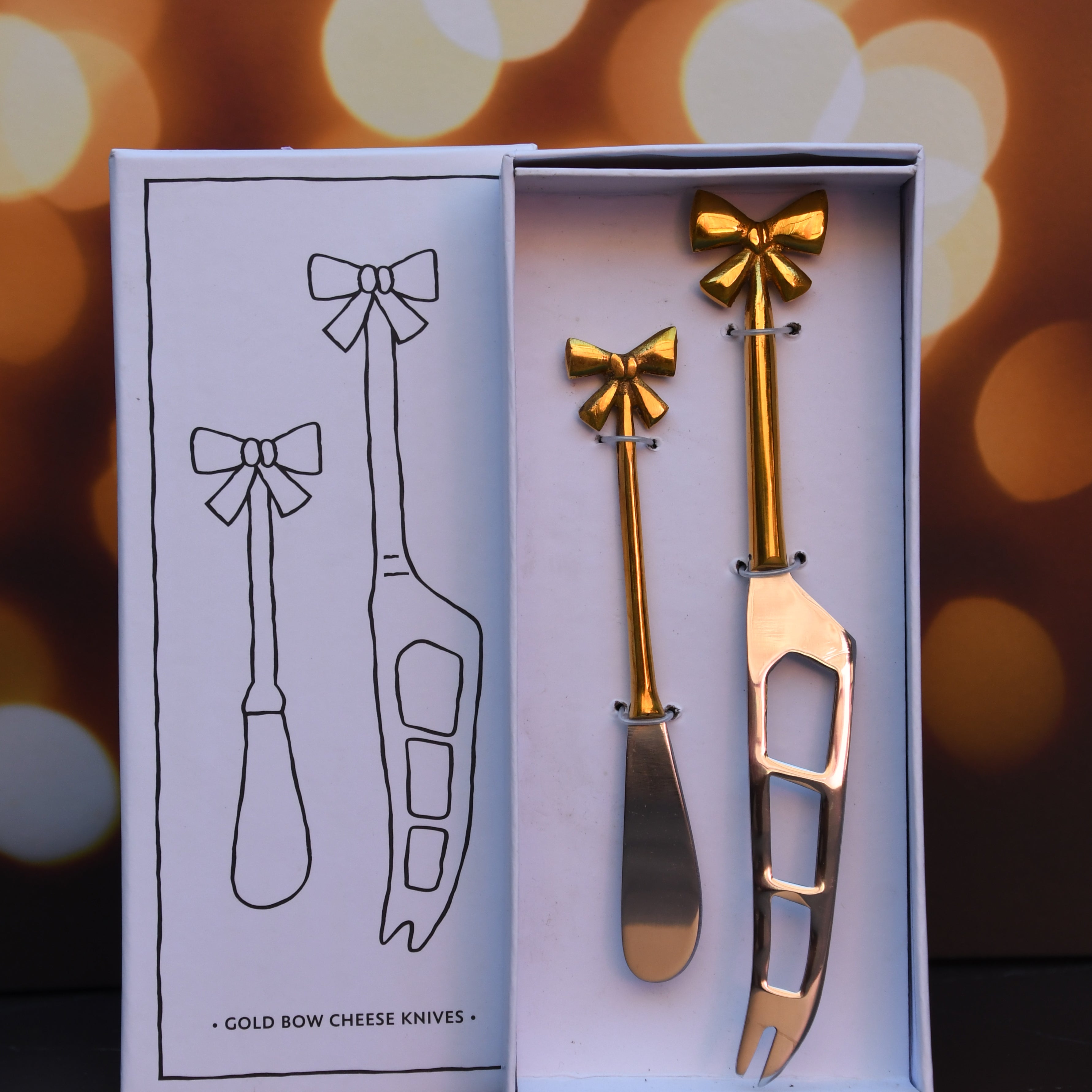 Cheese knives set of 2 with gold bows on handle.