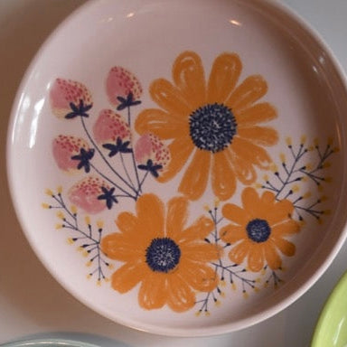 Ceramic plate with floral design on a white background
