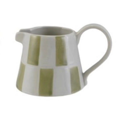 Ceramic pitcher with green and white striped design on a white background
