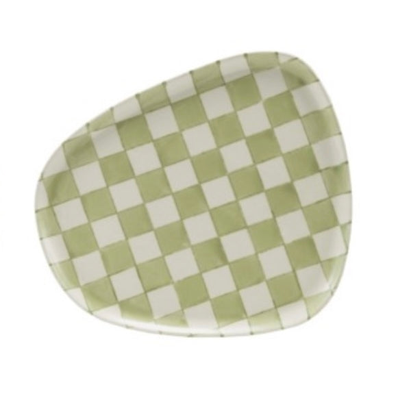 Checkered green and white plate on a white background