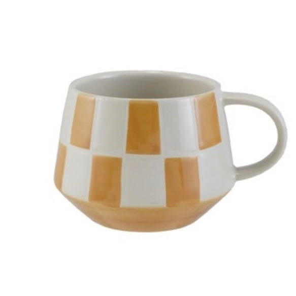 Mug with brown and white checkered pattern on a white background
