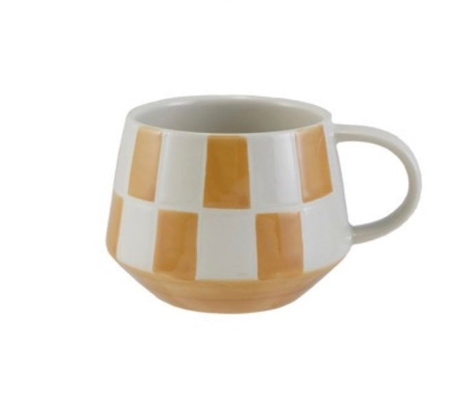Mug with brown and white checkered pattern on a white background