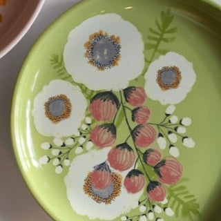 Decorative plate with floral design on a green background