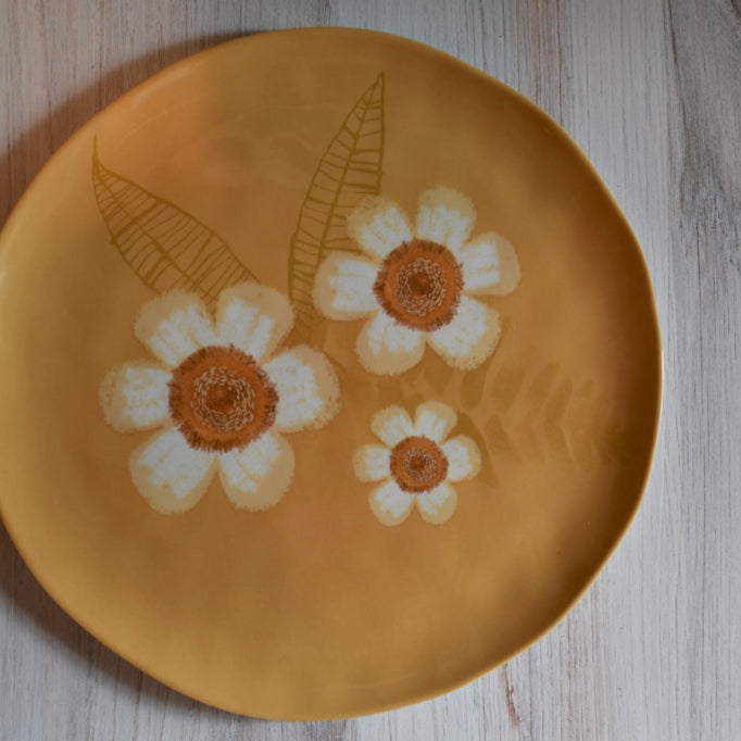 Plate with floral design on a wooden surface
