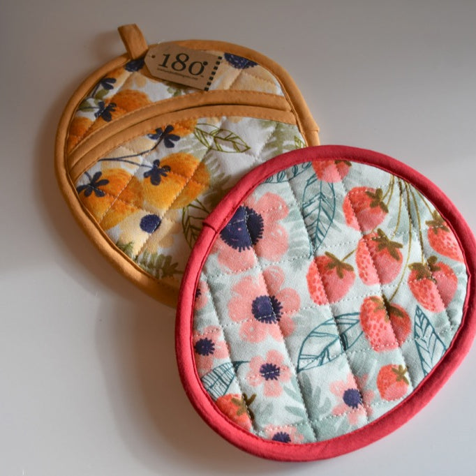 Two floral-patterned pot holders on a white background