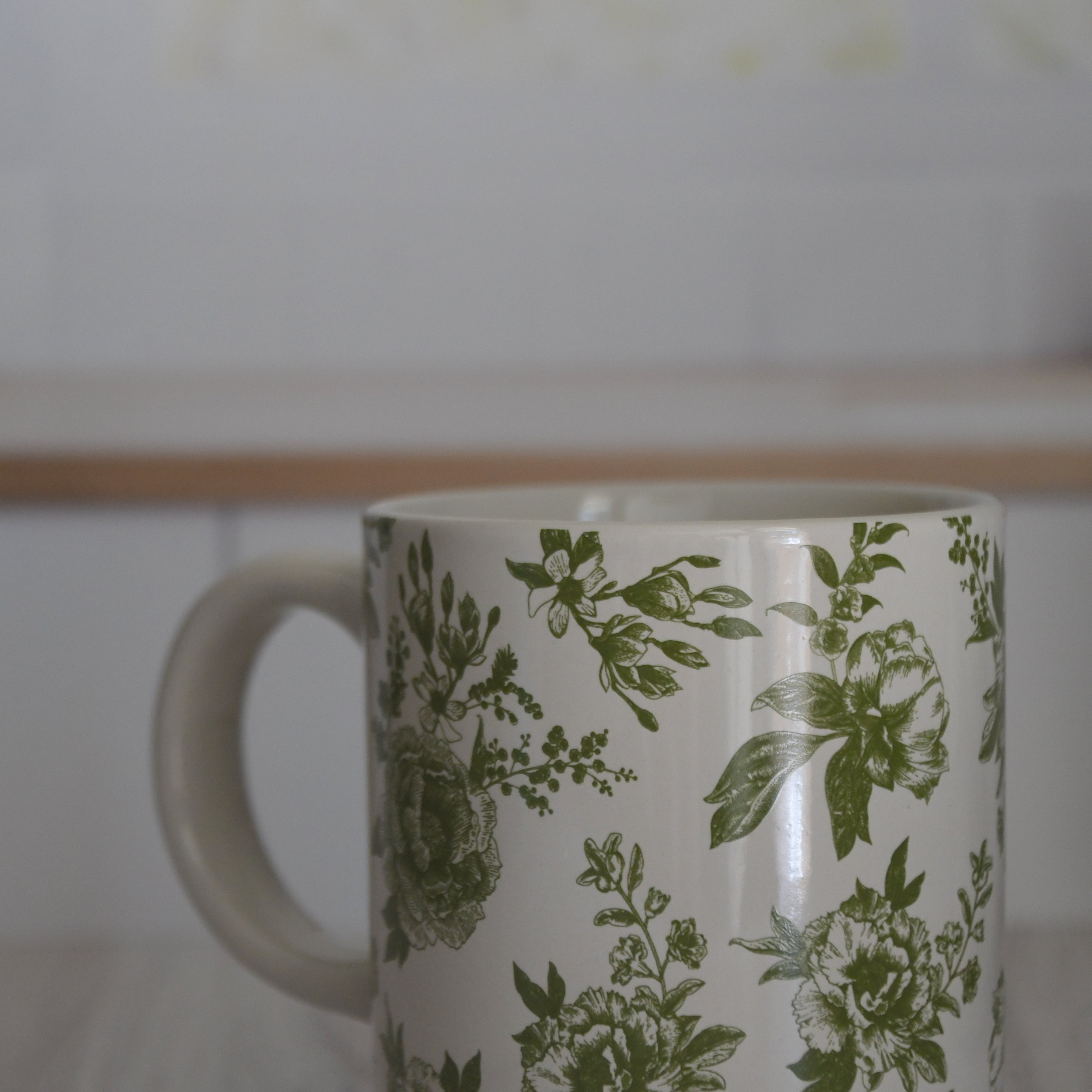 Mug with green floral pattern on a white background