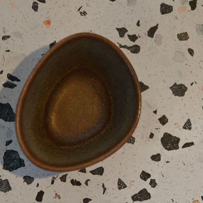 Ceramic bowl on a speckled surface