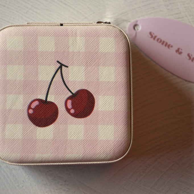 Small pink checkered pouch with cherry design on a light surface, featuring a 'Stone & Stitch' tag.