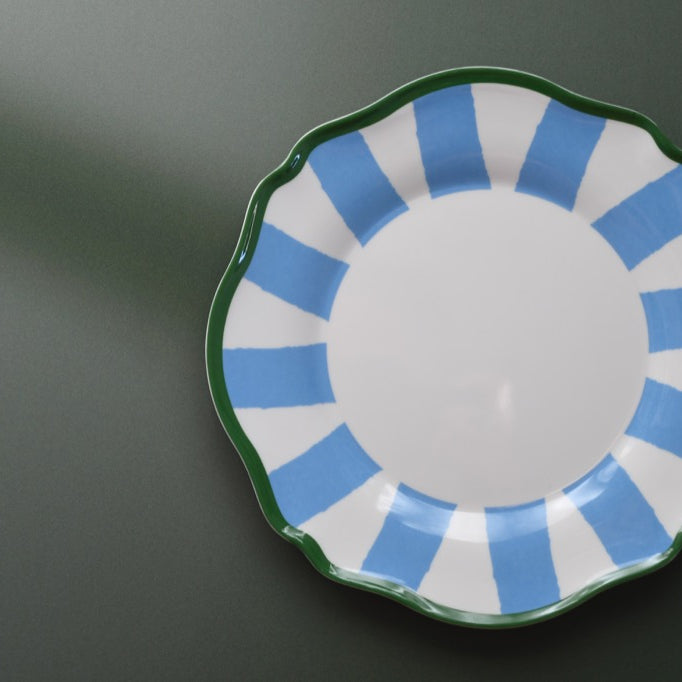 Plastic plate with blue and green design on a dark background
