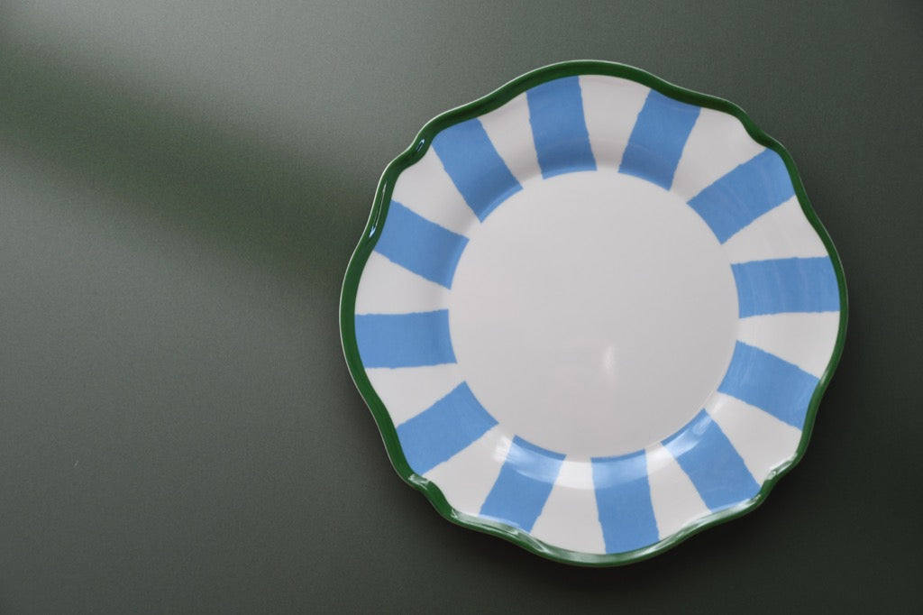 Plastic plate with blue and green design on a dark background