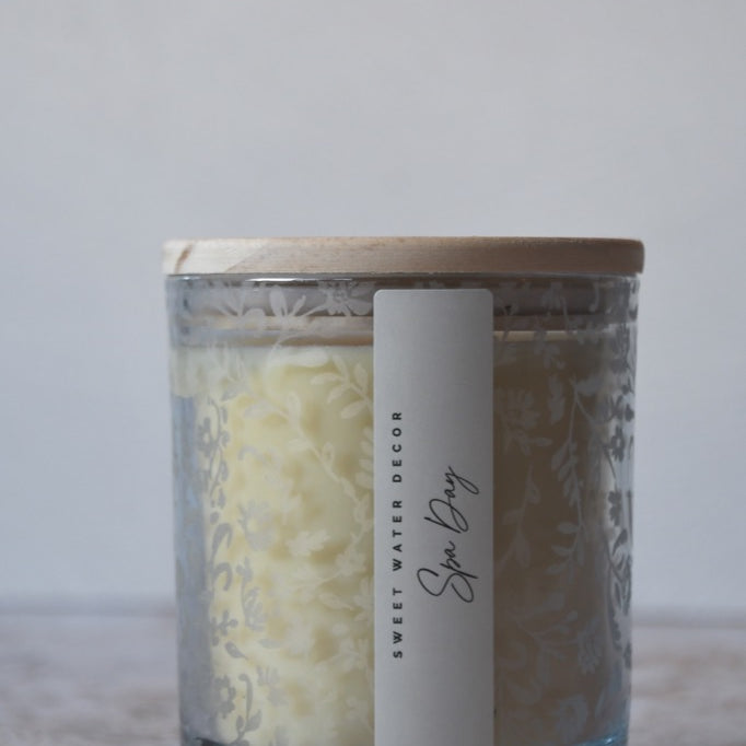 Glass jar with wooden lid and label on a light surface