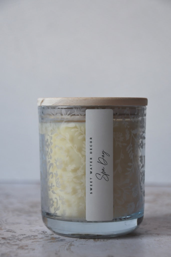 Glass jar with wooden lid and label on a light surface