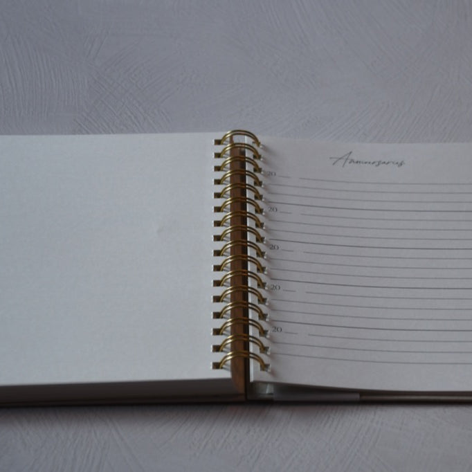 Open notebook with lined pages on a gray surface
