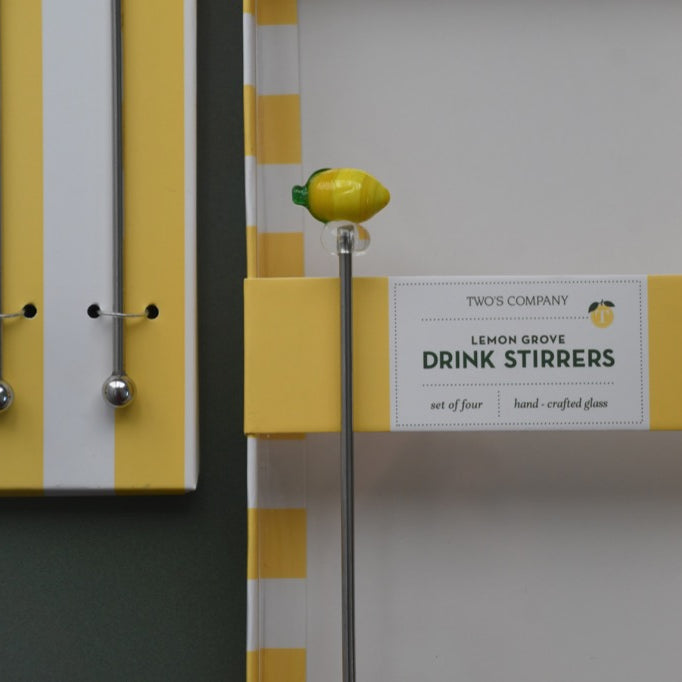 Packaging of drink stirrers with lemon design on a gray background