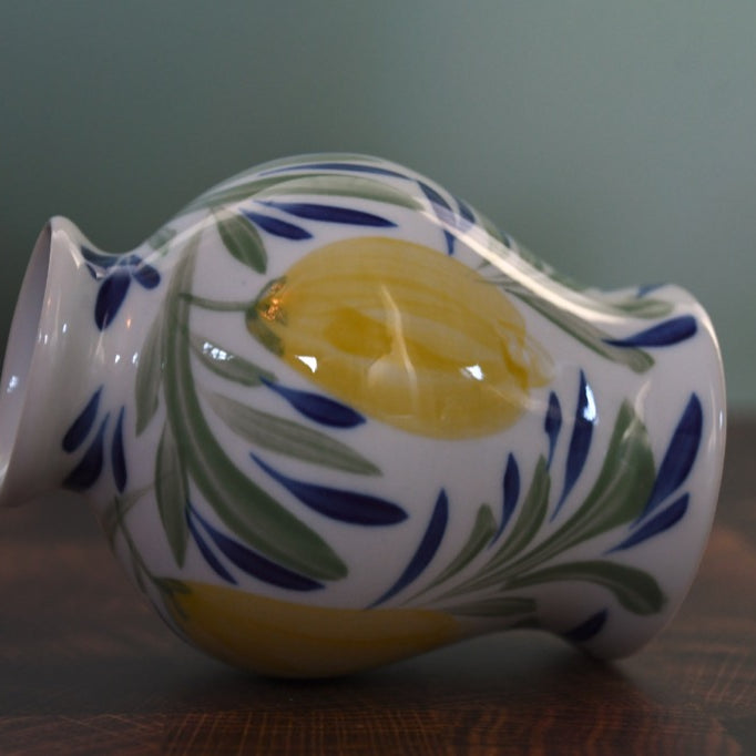 Decorative ceramic vase with floral patterns on a wooden surface