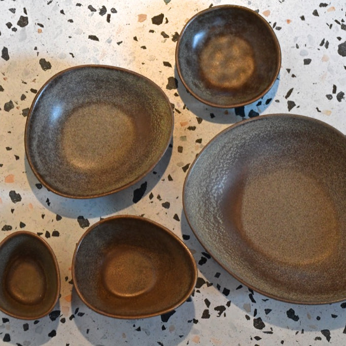 Set of ceramic plates on a speckled surface