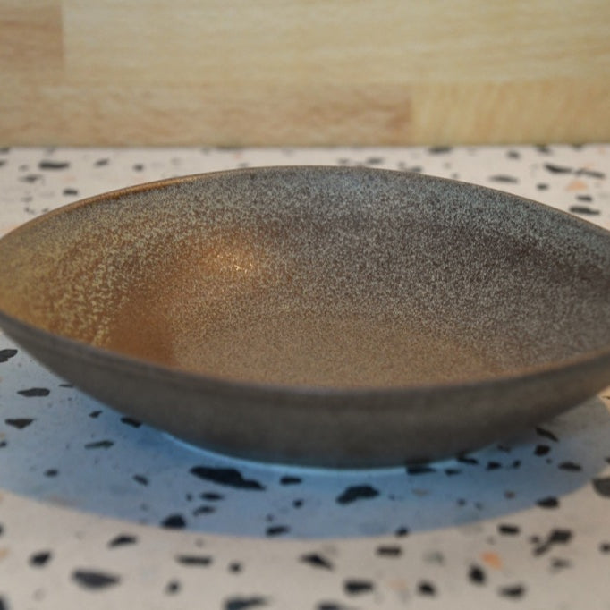 Decorative bowl on a speckled countertop