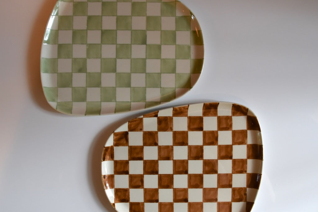 Two checkered ceramic plates on a white background