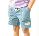 Boys Sawyer and Finn shorts in dusty teal. Front pockets and drawstring.