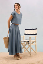 Chambray crop top with scoop neckline and cap sleeves. 