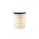 Candle with black lid and white body on a white background