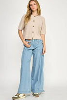 Beige button up the front sweater. 1/2 sleeve.
