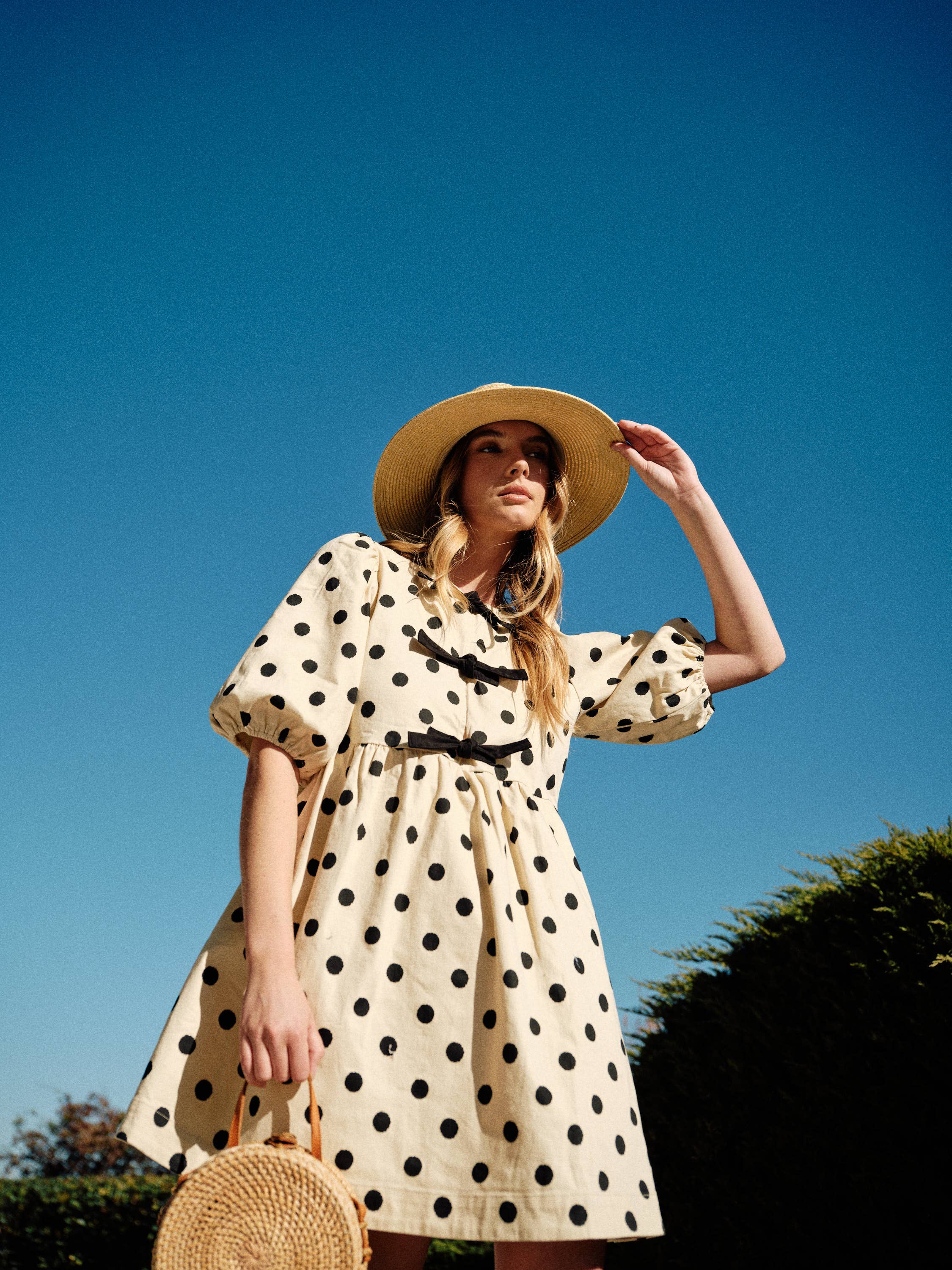 Polka dot babydolll with puff sleeves and bow front closure. 