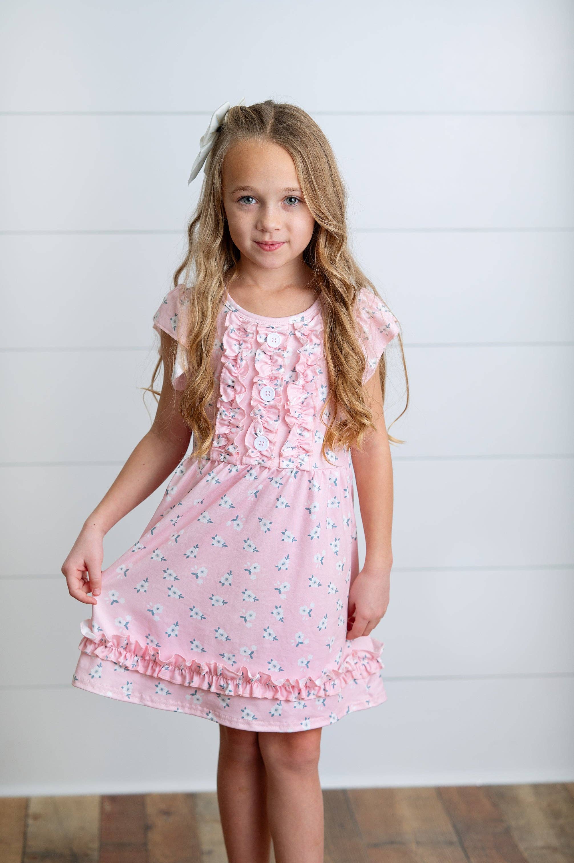 Girls Pink dress with buttons ruffles and flowers. 