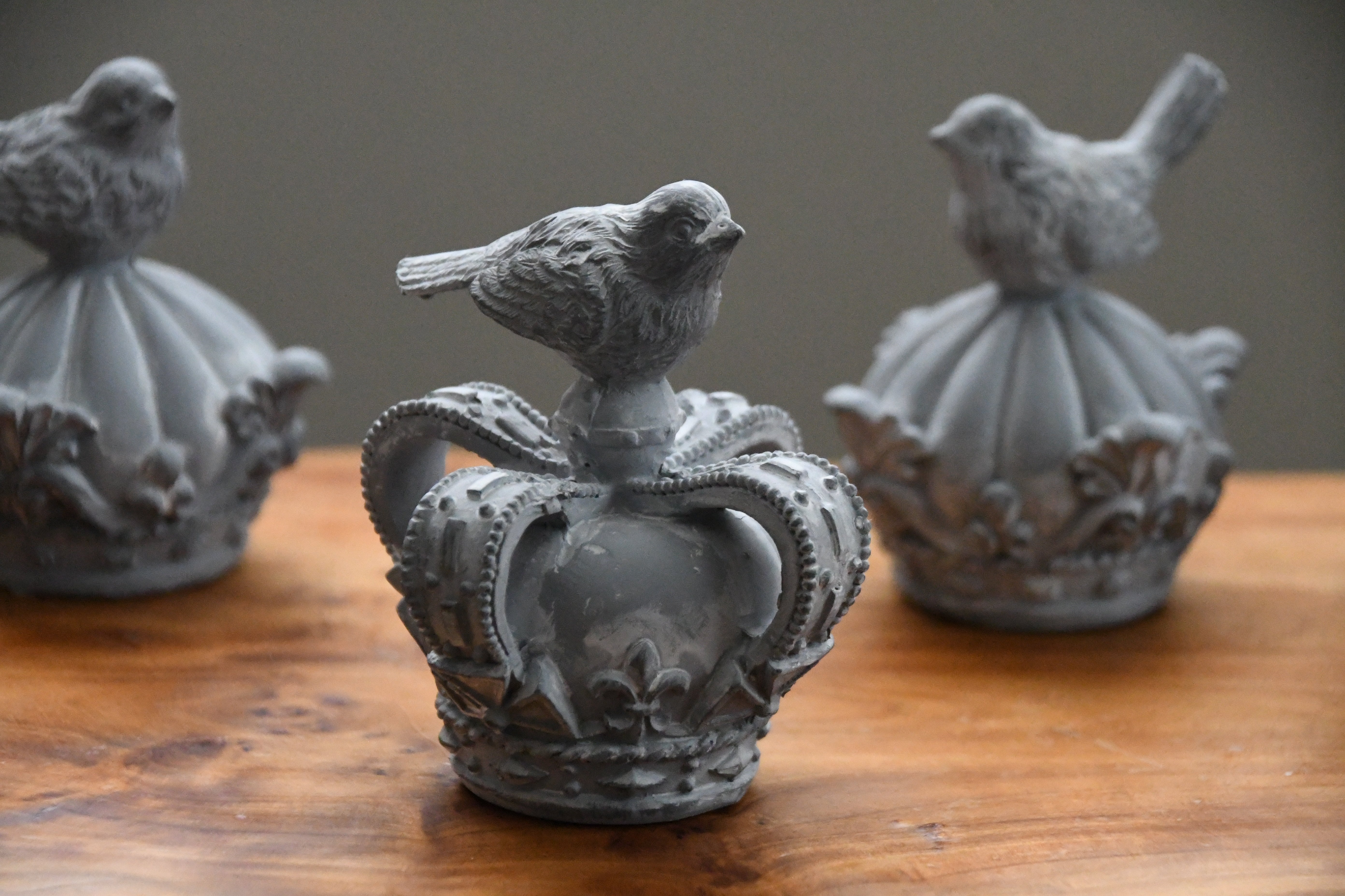 Decorative items with bird designs on a wooden surface
