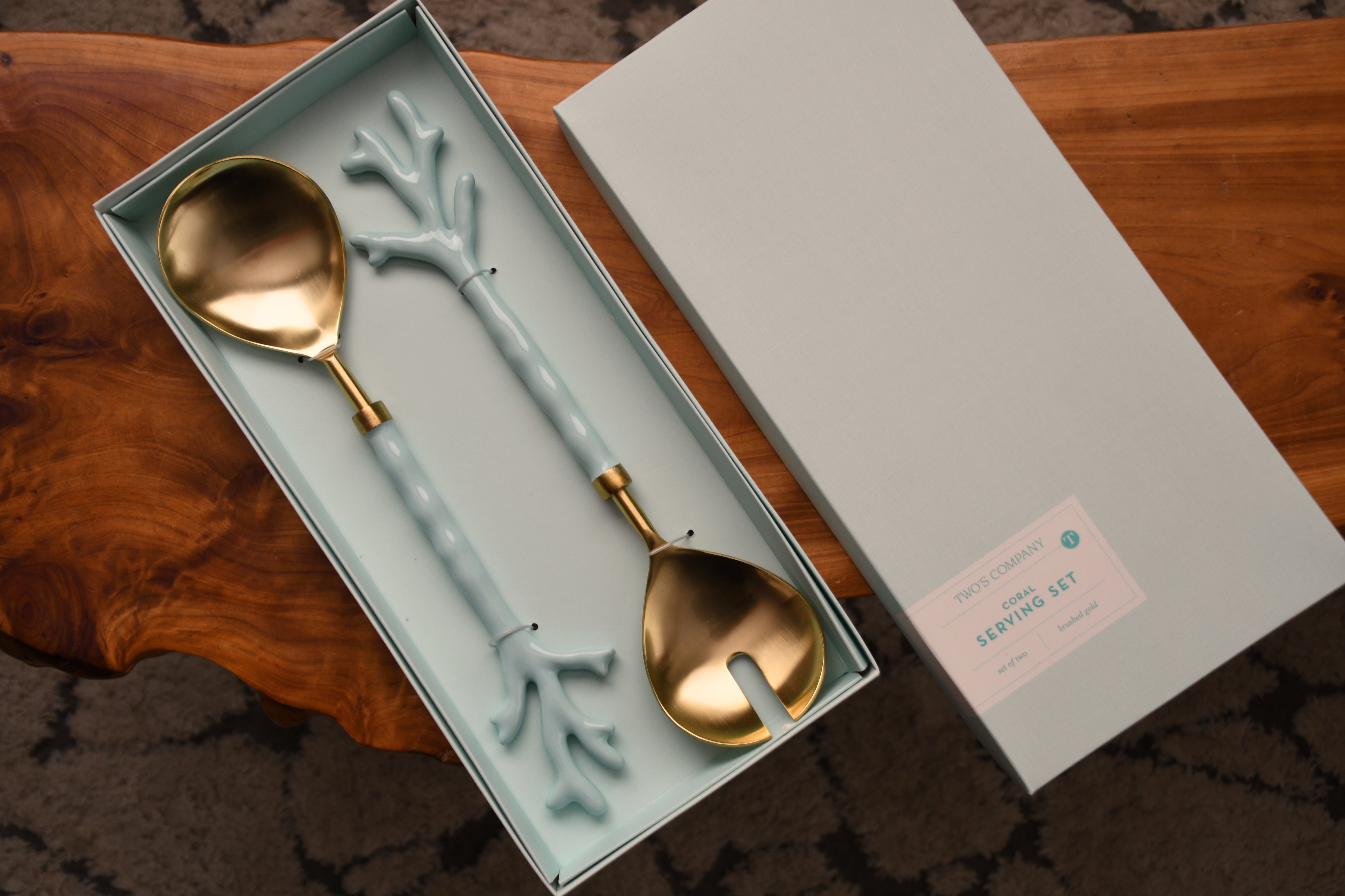 Set of decorative spoons in a box on a wooden surface