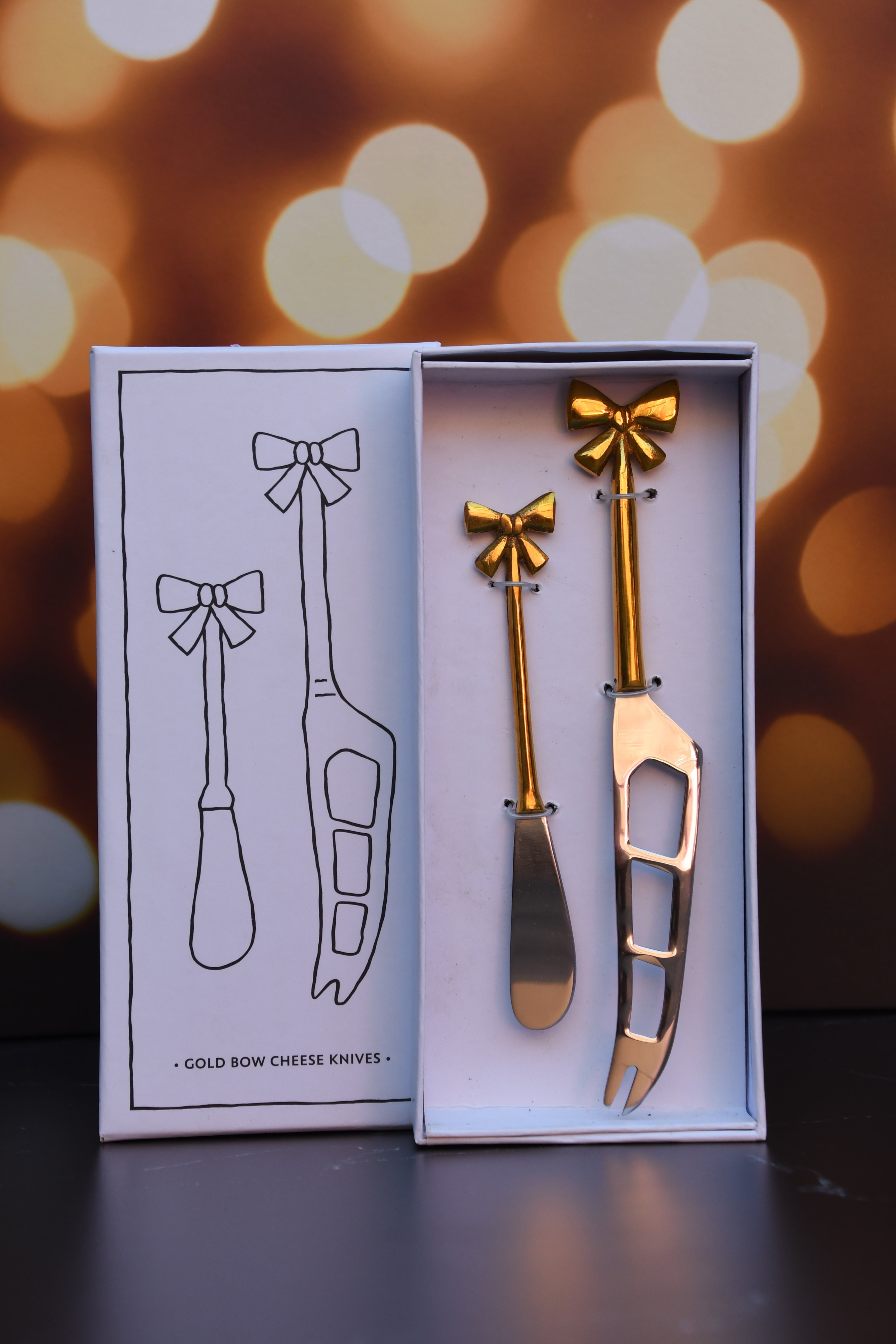 Cheese knives set of 2 with gold bows on handle.