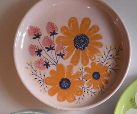 Ceramic plate with floral design on a white background