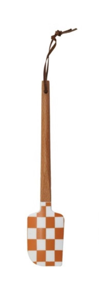 Checkered spatula with wooden handle on a white background