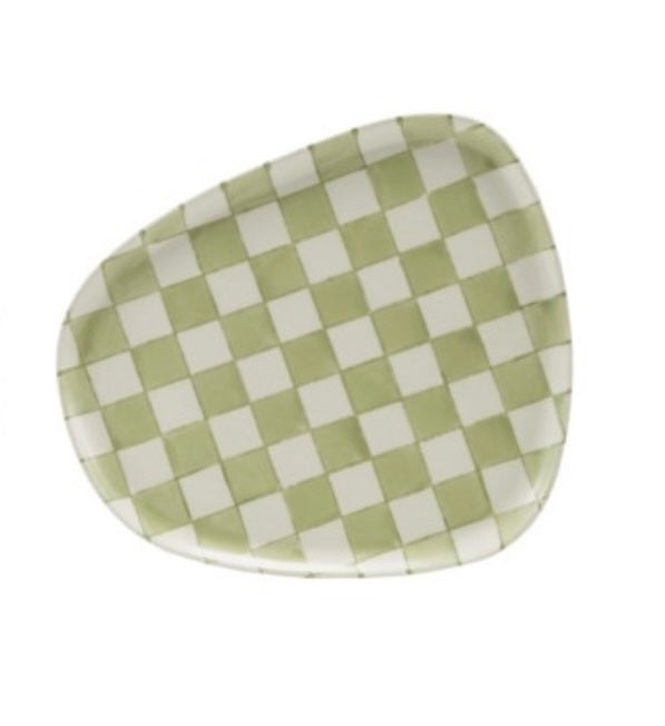 Checkered green and white plate on a white background