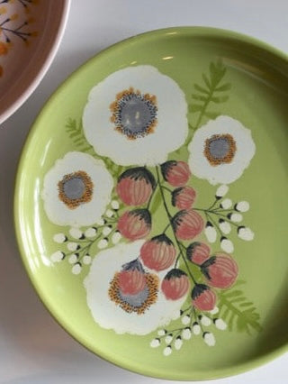 Decorative plate with floral design on a green background