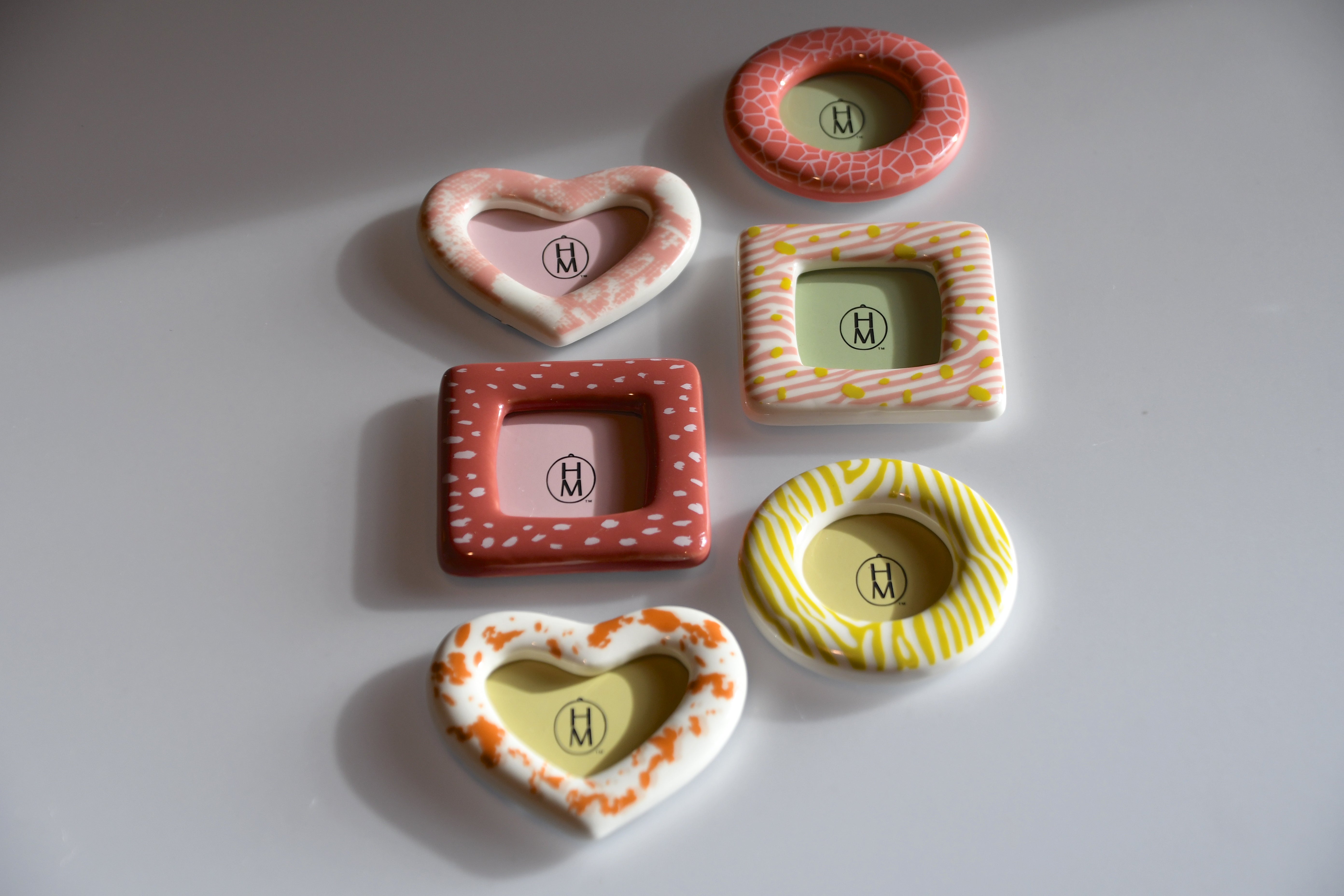Set of colorful ceramic frames on a light gray background