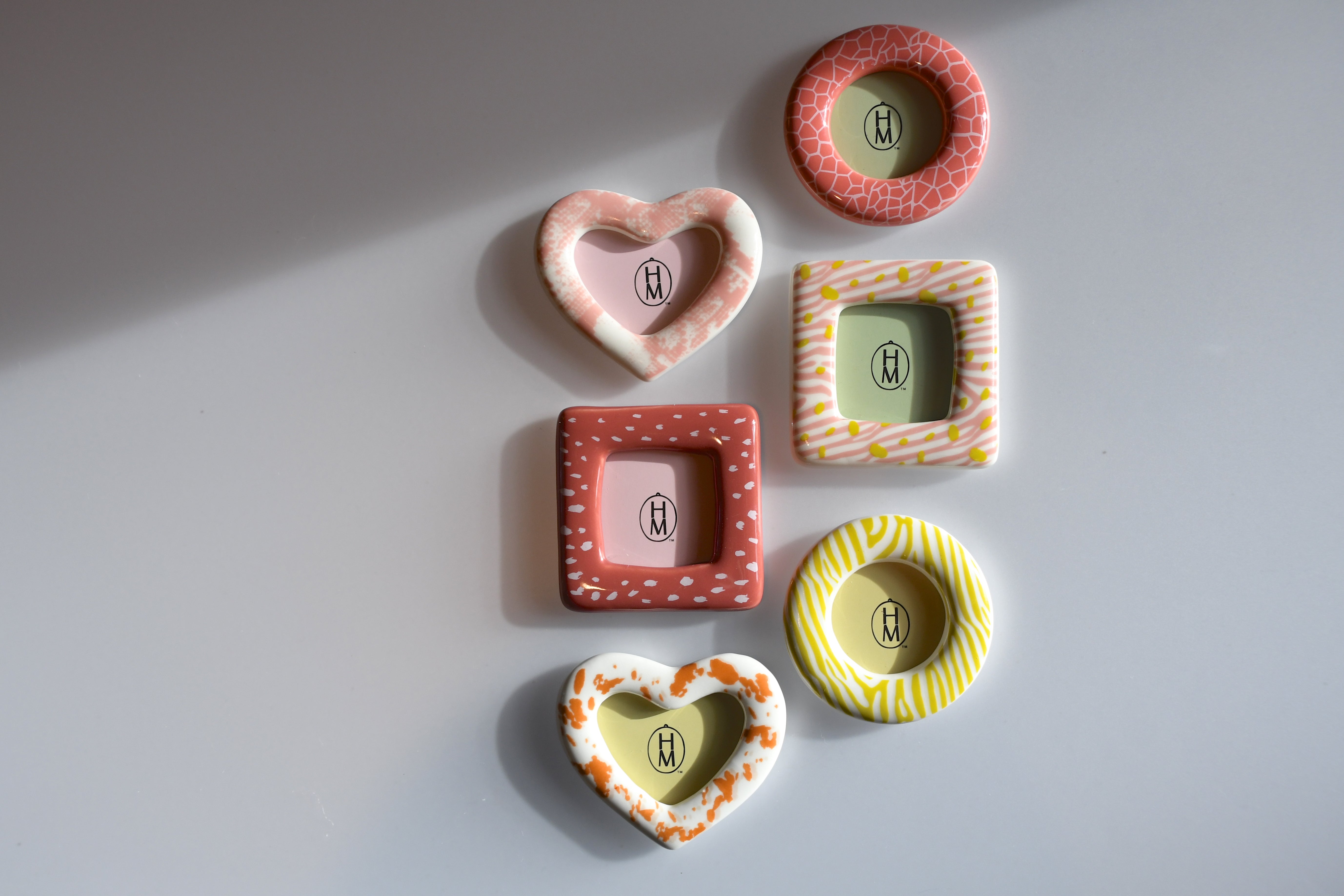 Set of colorful ceramic frames on a light gray background