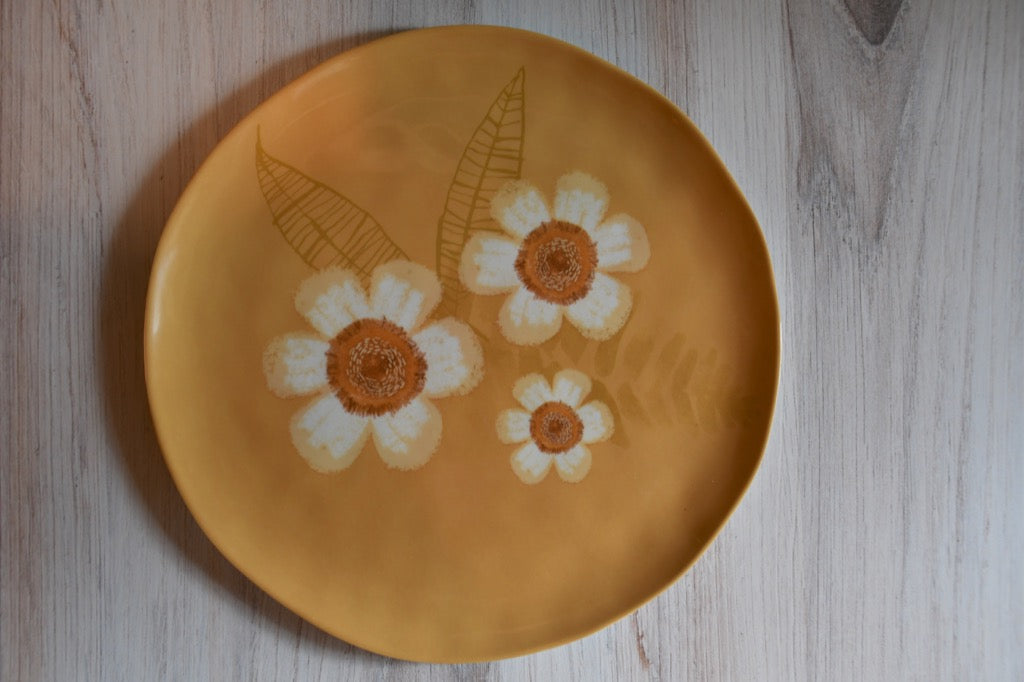 Plate with floral design on a wooden surface