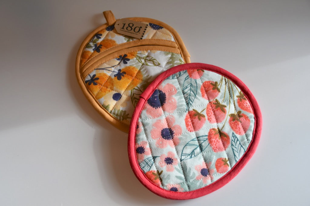Two floral-patterned pot holders on a white background