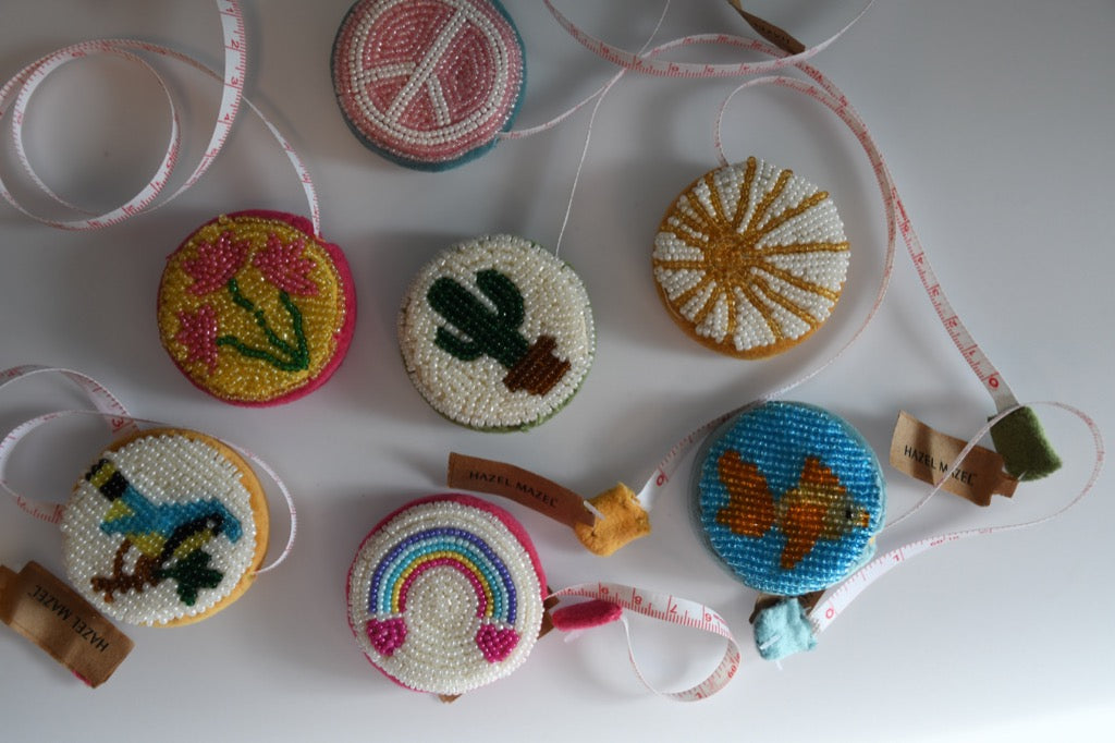 Decorative beaded measure with ribbons on a white surface