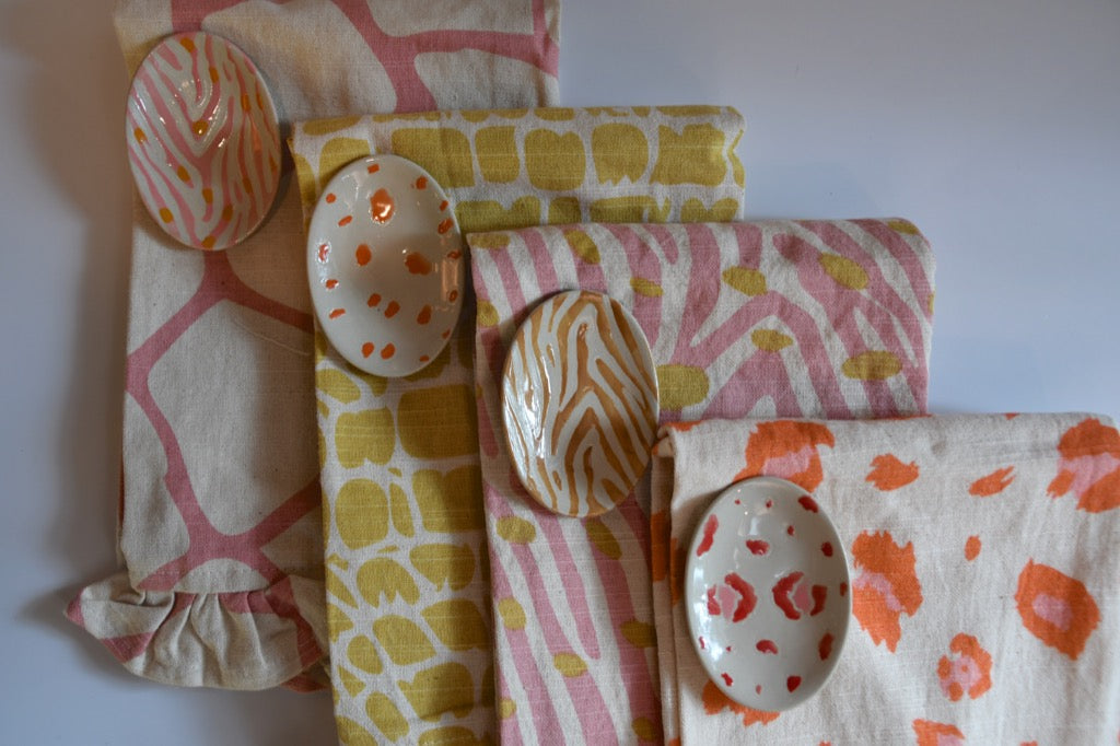 Set of patterned cloths with decorative stones on a white background