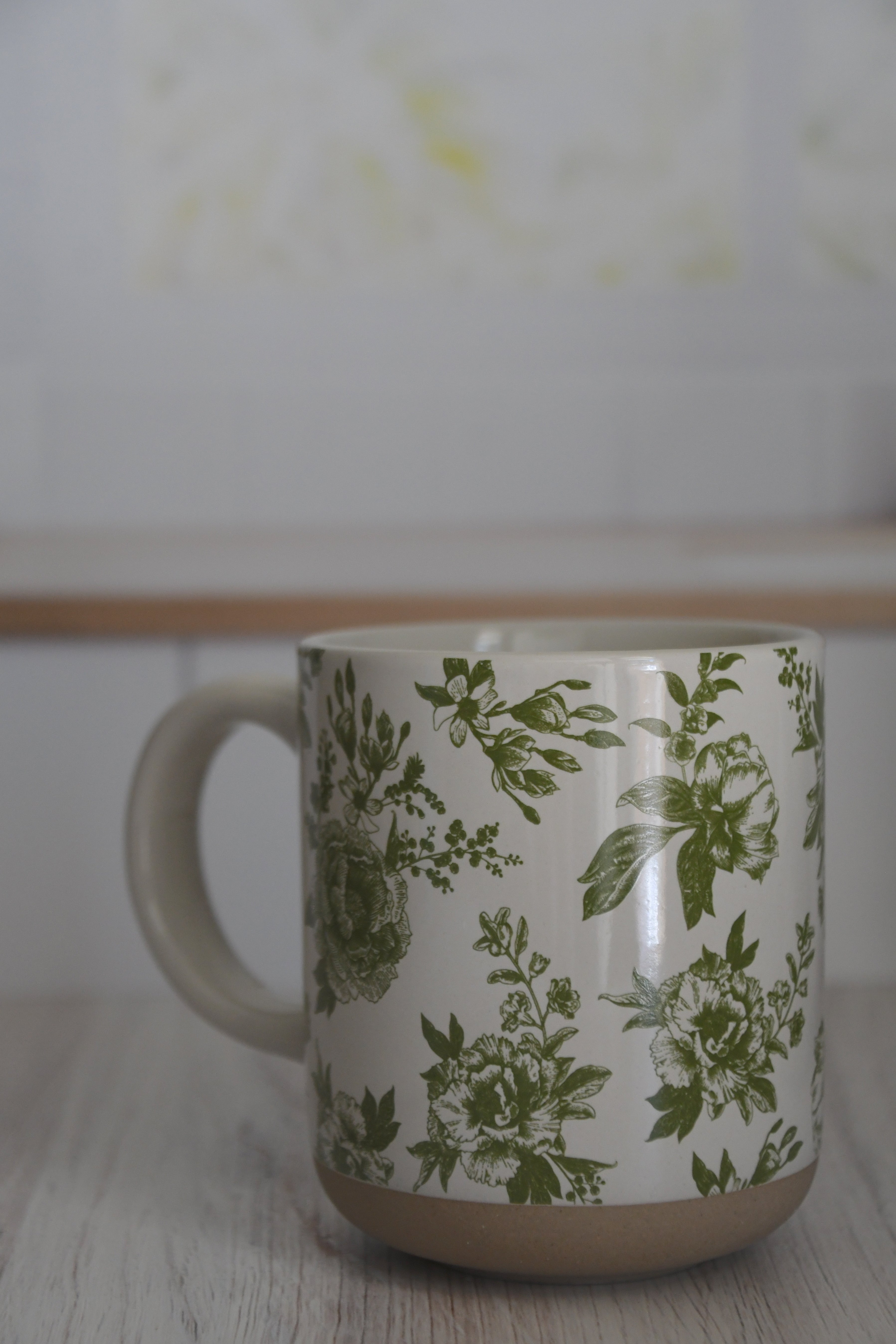Mug with green floral pattern on a white background