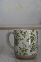 Mug with green floral pattern on a white background