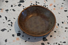 Brown ceramic bowl on a speckled countertop