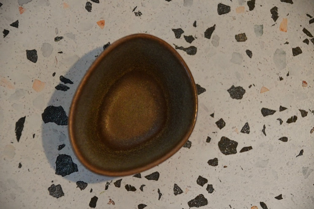 Ceramic bowl on a speckled surface