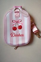 Pink and white striped pouch with cherry design and 'Dinker' text on a light gray background
