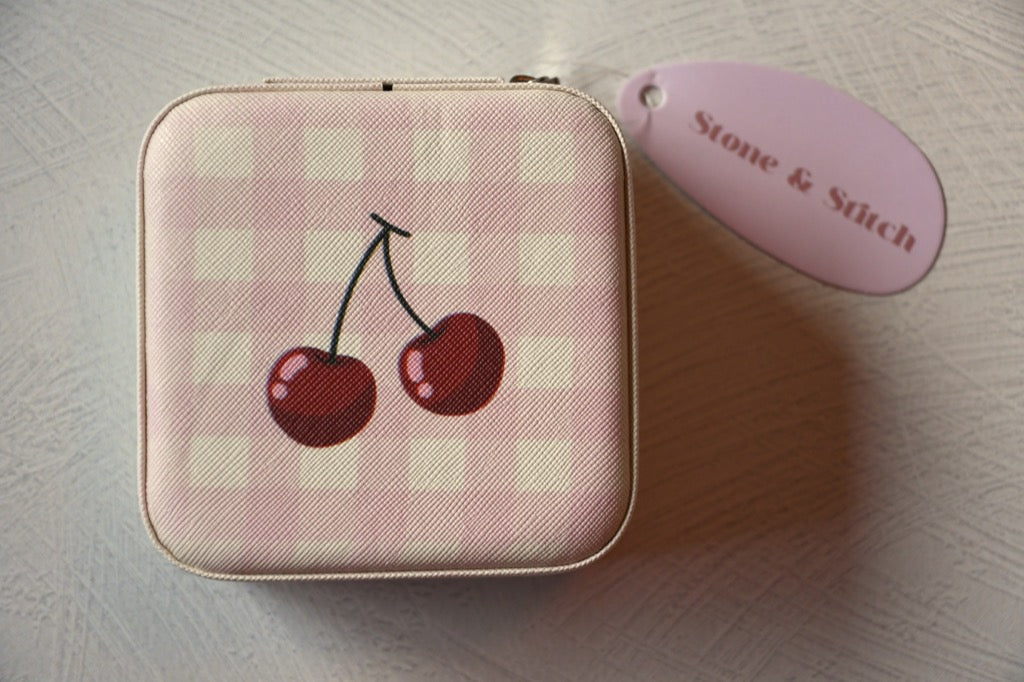 Small pink checkered pouch with cherry design on a light surface, featuring a 'Stone & Stitch' tag.