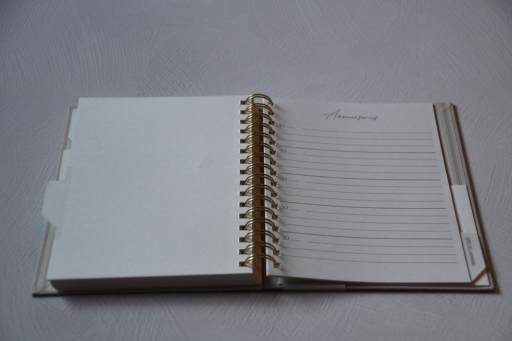 Open notebook with lined pages on a gray surface