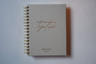Notebook titled 'Together Newly Weds Journal' on a light gray background